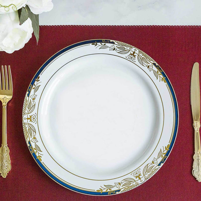 Elegant white plate with gold floral design on a red table setting.