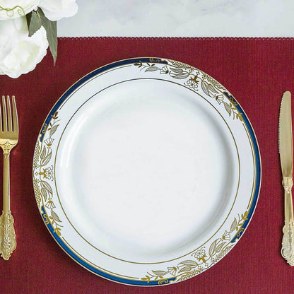 Elegant white plate with gold floral design on a red table setting.