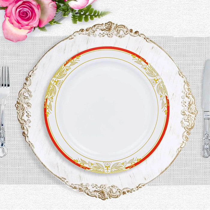 Elegant white plate with gold and red floral design on ornate charger.