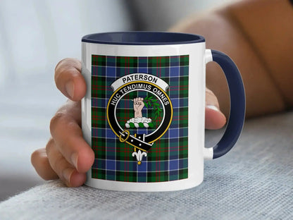 Navy-accent Paterson mug held in a hand, showing a hand holding a leafy branch and Huc Tendimus Omnes motto.