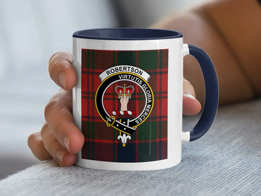 Navy-accent Robertson mug held in a hand, showing the crowned-hand crest and Virtutis Gloria Merces motto.