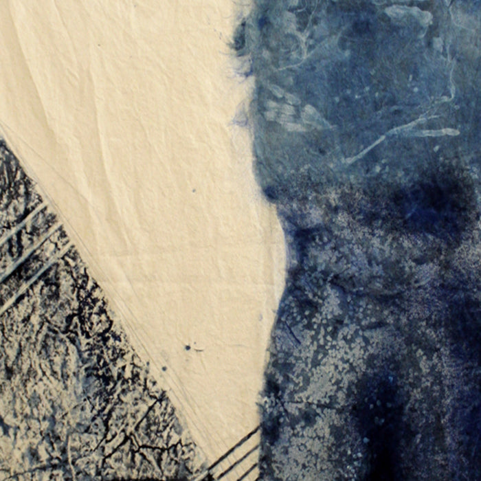 The artwork 'Crepuscular' by Johanna Ryan features a dramatic composition in cyanotype on coffee-dyed canvas. Abstract forms divide the piece diagonally, with deep indigo blues contrasting against warm cream tones. Textural elements create a crackled, organic pattern in the lower left, while the upper right shows ethereal, cloudlike blue washes characteristic of the cyanotype process.