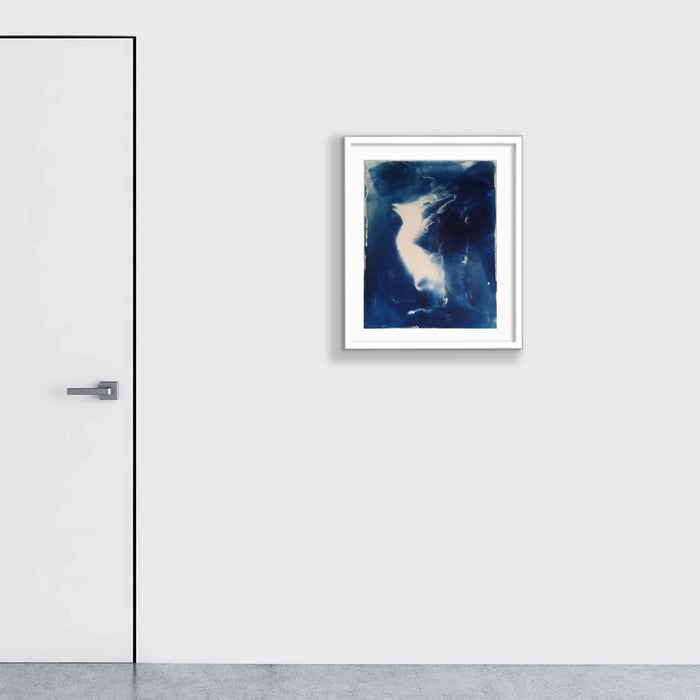 The artwork 'Embryonic Stage 3' by Johanna Ryan features a striking cyanotype print with ethereal white forms floating against a deep Prussian blue background. The abstract composition suggests organic, flowing shapes reminiscent of embryonic development, rendered in a dreamy, photographic blue tone characteristic of the cyanotype process on paper. White border frame enhances the presentation.