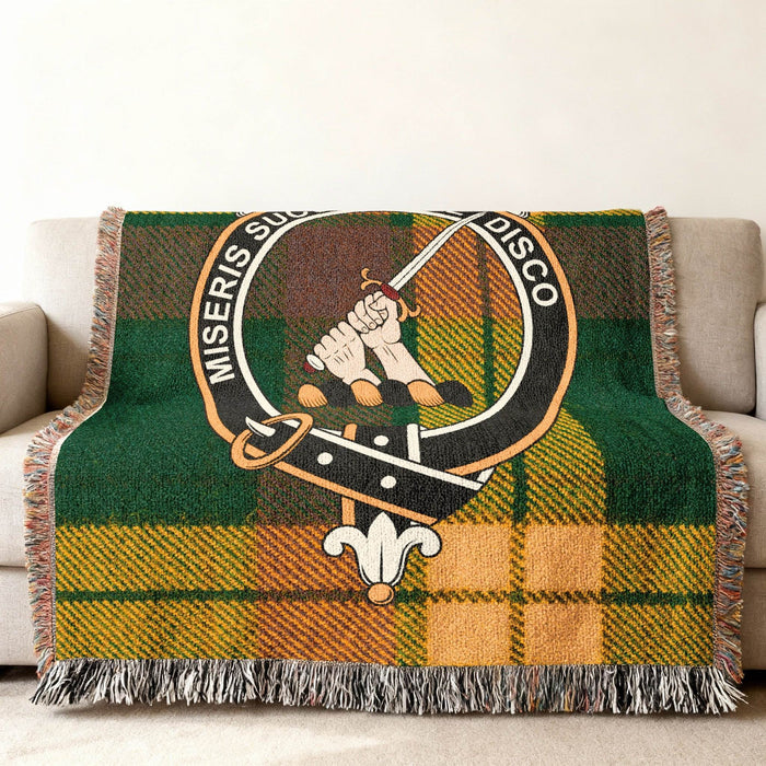 MacMillan woven blanket with crest over a tartan background and fringe