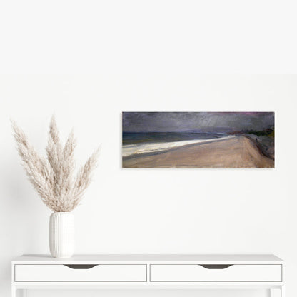 The artwork 'Sandy Hook' by Peter Colquhoun depicts a moody coastal landscape with a sweeping sandy beach curving along dark waters. Stormy grey clouds hover above, creating dramatic contrast with the beige shoreline. Oil on linen technique brings rich texture and depth to the seascape, capturing the raw beauty of the coastline.
