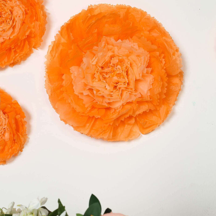 Orange paper flower wall decor for events and celebrations.
