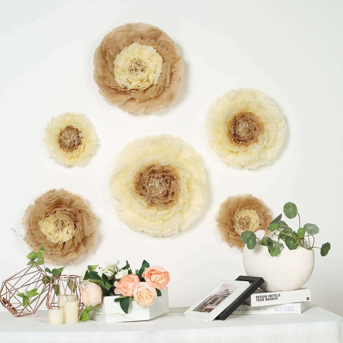 Decorative paper flowers in soft beige and cream hues on a wall with a floral arrangement.