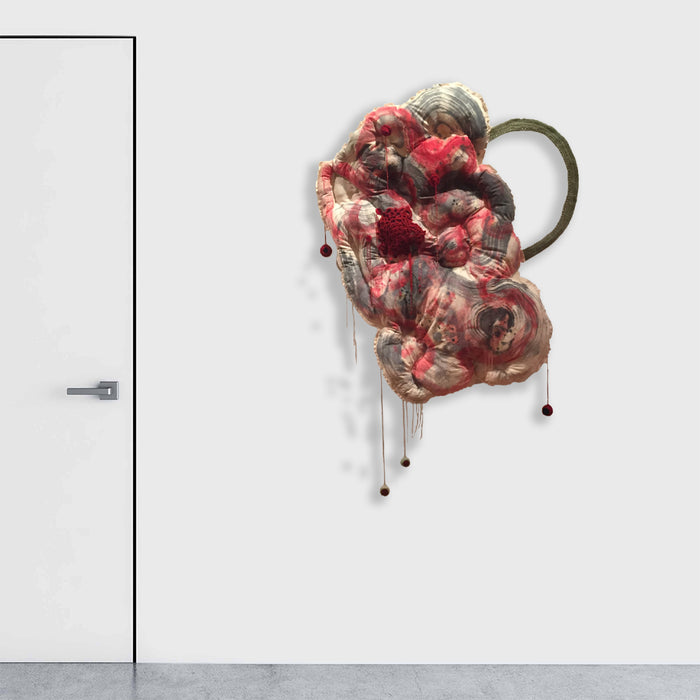 Study for Spiritual Interpretation of Artificial Object by Noriko Okada: Abstract monoprint on fabric featuring organic, cloud-like formations in deep crimson and gray tones with dripping elements. The composition creates a flowing, biomorphic shape with metallic accents and dangling orb details, mounted against a white wall. 60x36 inches.