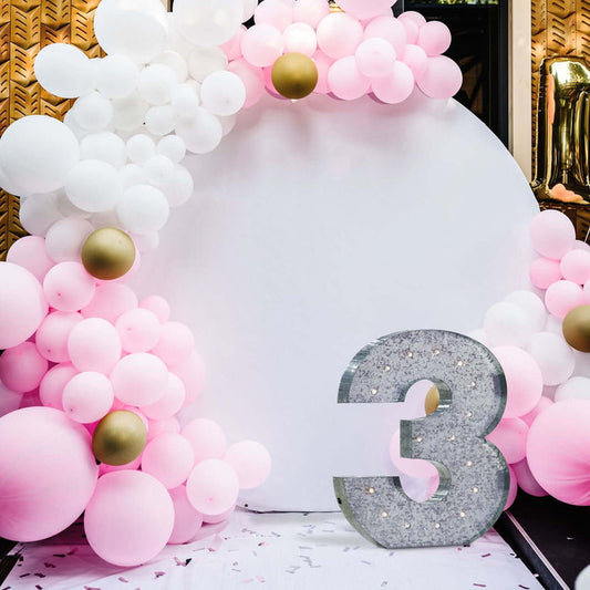 Decorative balloon arch with a large number three for a celebration.