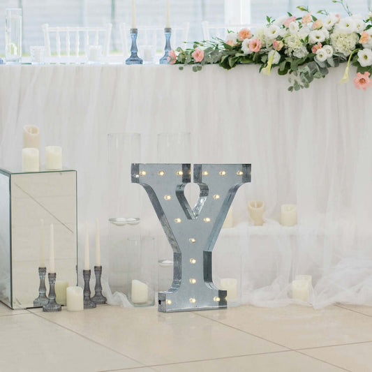 Decorative illuminated letter "Y" for wedding or event decor.